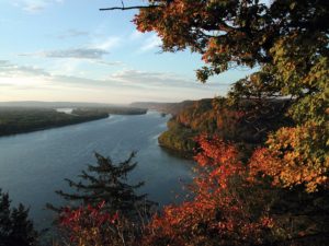 View from a bluff overlooking the Upper Mississippi River, with a colorful mix of fall leaves in the foreground.