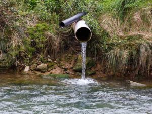 Water pouring from a drain into a river