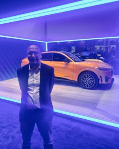 ELPC's Rob Kelter stands in front of an electric vehicle at the Chicago Auto Show 2022