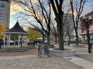 Photo of a gazebo in a plaza with bike racks surrounded by shops in downtown Lima, OH, where a proposed amtrak train could connect the town to Columbus and Fort Wayne