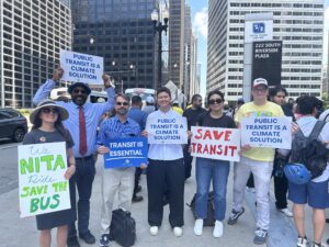 Six members of the ELPC team attend a rally for transit at Chicago's Union Station, holding signs that read "Public Transit is Climate Action," "Save Transit," "Transit is Essential," and "We NITA Ride, Save the Bus" which is a play on words because the bill would create a new regional Northern Illinois Transit Authority, and the acronym NITA can be pronounced like "need a"
