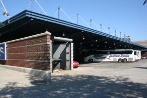 An Indian Trailways Bus is parked at Chicago's Greyhound intercity bus station on a sunny day