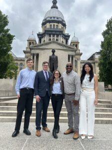 Five ELPC staffers smile in front of the Lincoln statue in front of the Illinois Statehouse in springfield during the May lobby day.